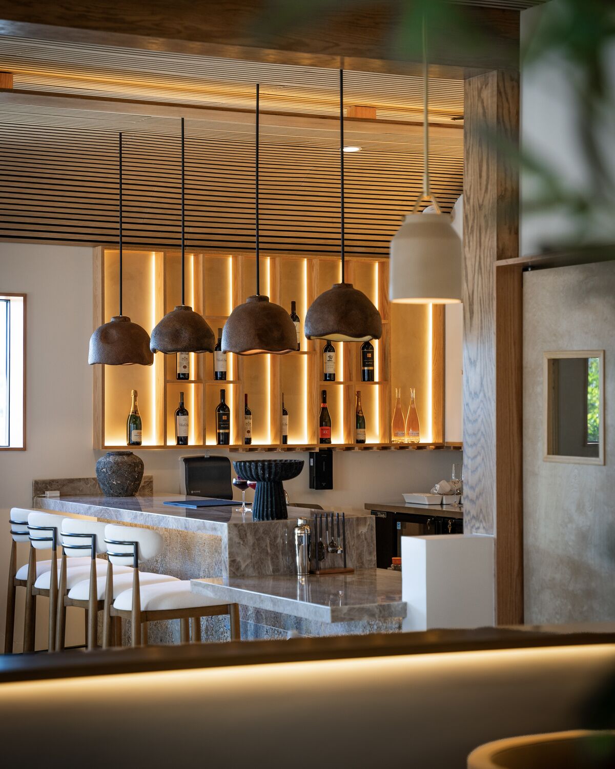Marble bar and pendant lighting in the Toranj dining room in Manhattan Beach