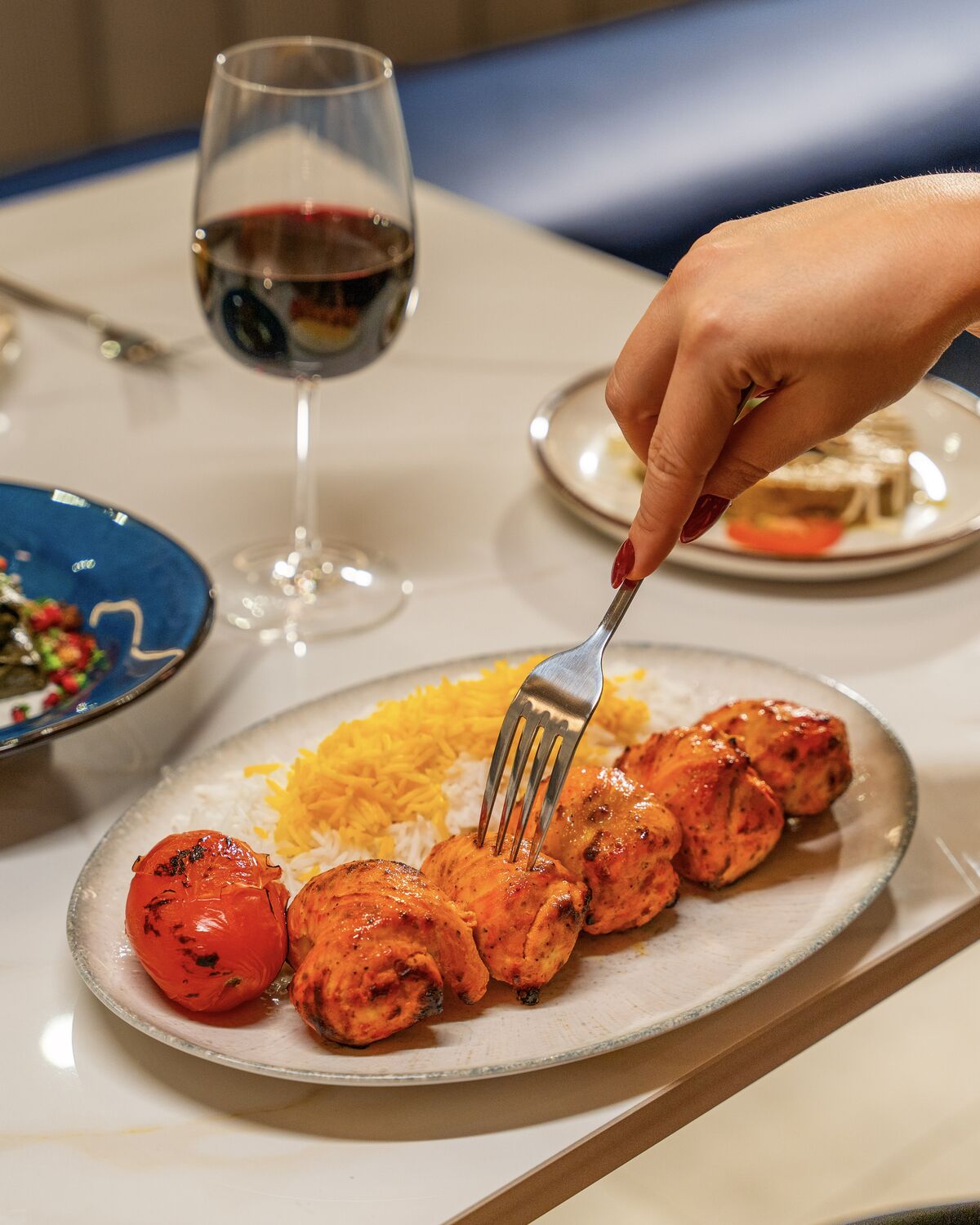 Joojeh kabob with grilled tomato and saffron basmati rice in Manhattan Beach