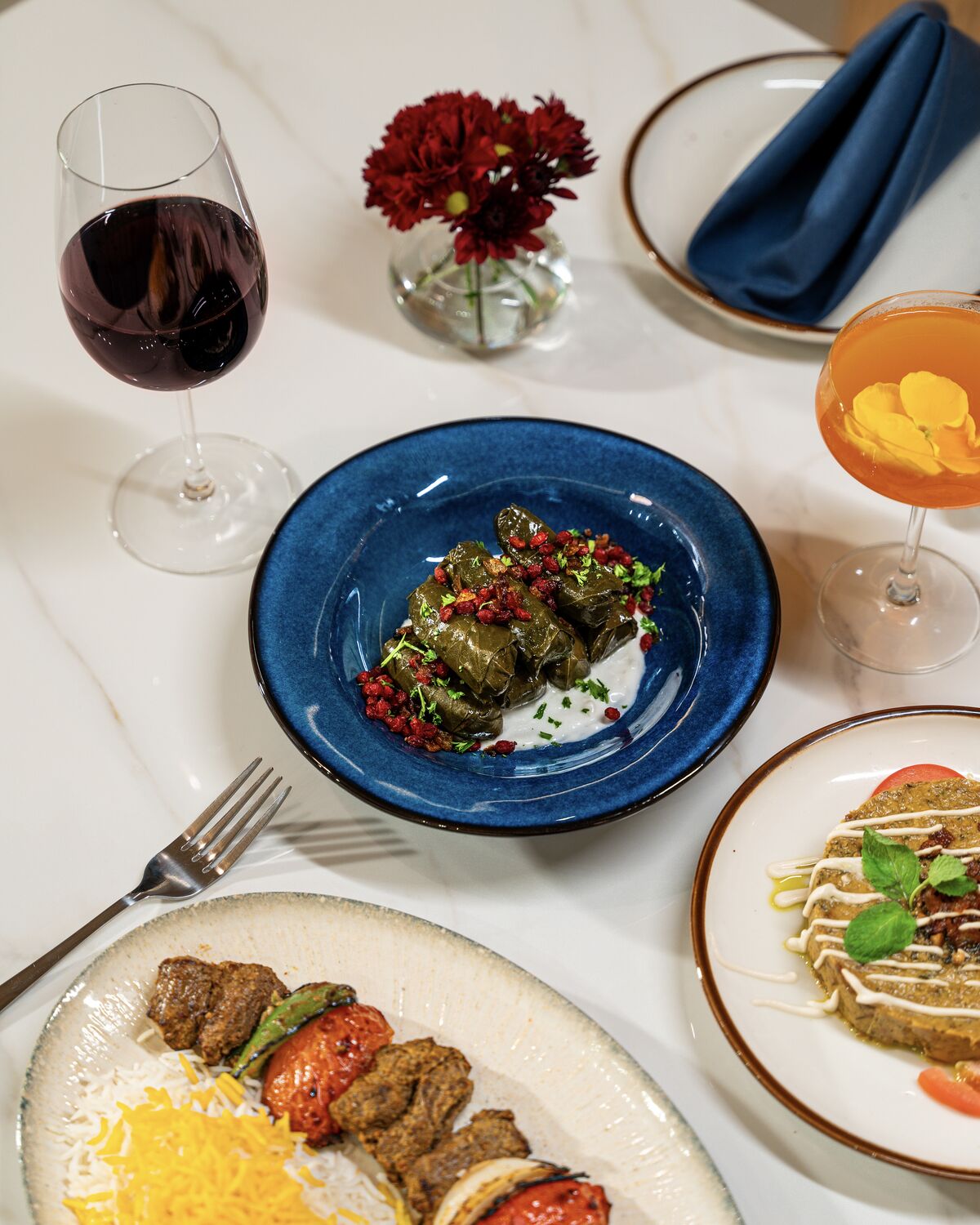 Dolmeh, kabob and saffron basmati rice laid out on the table in Manhattan Beach