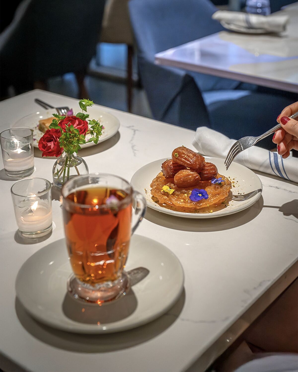 Zoolbia bamieh dessert served with a glass of Persian tea in Westwood Village